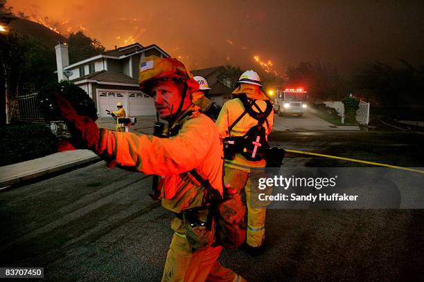 Firefighters battle a blaze November 15, 2008 in Yorba Linda, California. Strong Santa Ana winds are fanning flames throughout Southern California,...