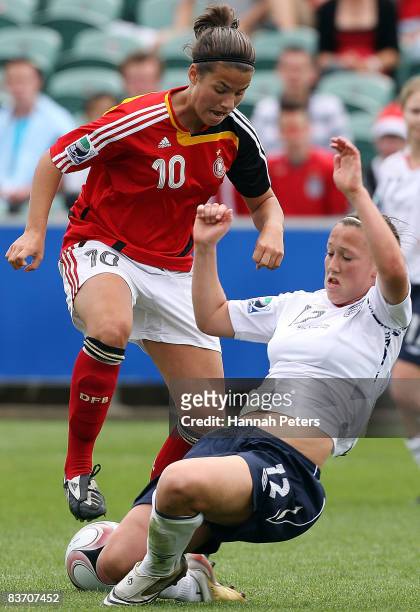 Lucy Bronze of England tackles Dzsenifer Marozsan of Germany during the FIFA U17 Women's World Cup Third and Fourth Playoff match between England and...