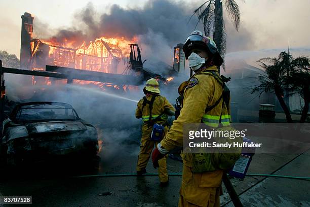 Firefighters battle a blaze November 15, 2008 in Yorba Linda, California. Strong Santa Ana winds are fanning flames throughout Southern California,...