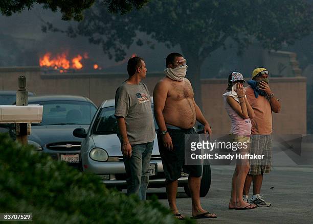 Residents watch homes burn November 15, 2008 in Yorba Linda, California. Strong Santa Ana winds are fanning flames throughout Southern California,...