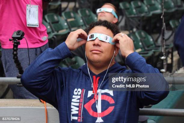 Bartolo Colon of the Minnesota Twins wears protective eclipse glasses as he looks at the solar eclipse during game one of the doubleheader against...