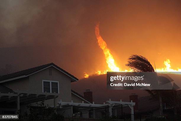 Fire tornado comes close to homes during the Corona Fire on November 15, 2008 in Yorba Linda, California. Strong Santa Ana Winds are destroying...