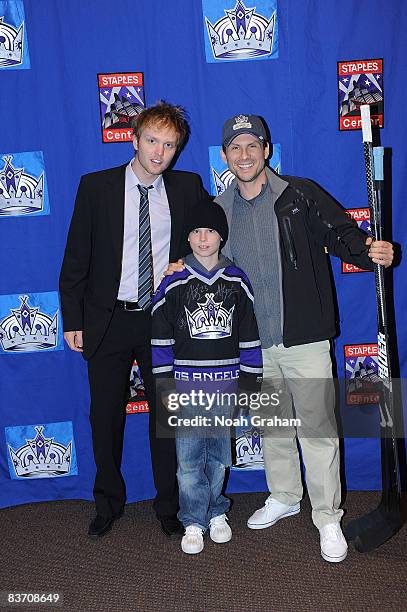 Erik Ersberg of the Los Angeles Kings poses for a photo with Actor Christian Slater and son after the game against the Nashville Predators on...