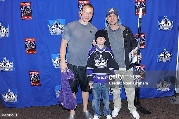 Dustin Brown of the Los Angeles Kings poses for a photo with Actor Christian Slater and son after the game against the Nashville Predators on...