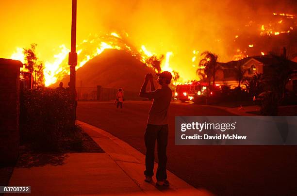 Residents watch as fire comes close to their homes on November 15, 2008 in Yorba Linda, California. Strong Santa Ana Winds are destroying hundreds of...