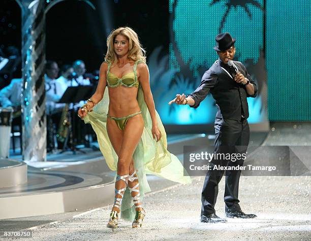 Recording artist Usher performs as Victoria's Secret Angel Doutzen Kroes walks the runaway during the 2008 Victoria's Secret Fashion Show at the...