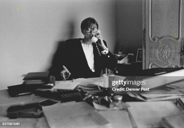 Katie Hill at her desk at the store -- a tough businesswoman -- she trys to make a deal with a supplier. Credit: The Denver Post