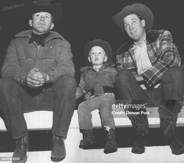 Adults one boy, Left to Right, Ben Johnson of Los Angeles, a rodeo contestant; Roy Dee Fort, 2 of Lovington, N.M., son of cowboy Troy Fort who was...