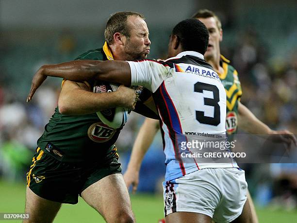 Australia's Glen Stewart is tackled by Fiji's Wes Naiqama during their Rugby League World Cup semi-final match in Sydney on November 16, 2008....