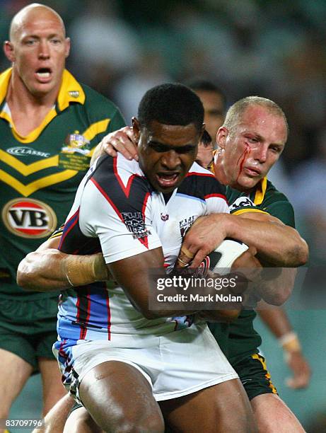 Wes Naiqama of Fiji is tackled by Darren Lockyer of the Kangaroos during the 2008 Rugby League World Cup Semi Final match between the Australian...