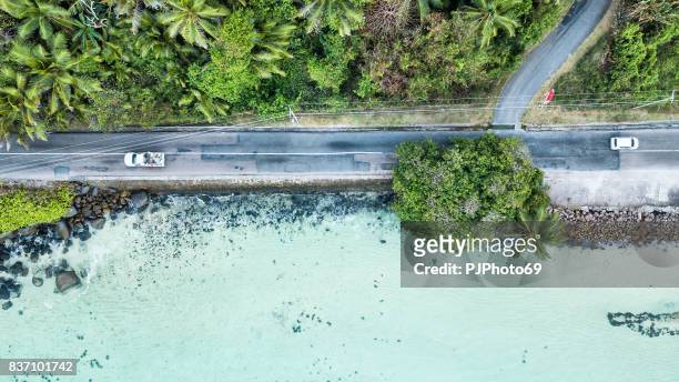 aerial view of main road of mahe island on the sea - seychelles - pjphoto69 stock pictures, royalty-free photos & images