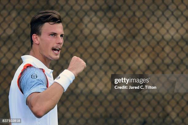 Marton Fucsovics of Hungary reacts after a point against Ernests Gulbis of Latvia during the third day of the Winston-Salem Open at Wake Forest...