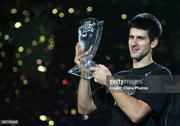 Novak Djokovic of Serbia holds up the winner's trophy following his victory over Nikolay Davydenko of Russia at the men's singles final match in the...