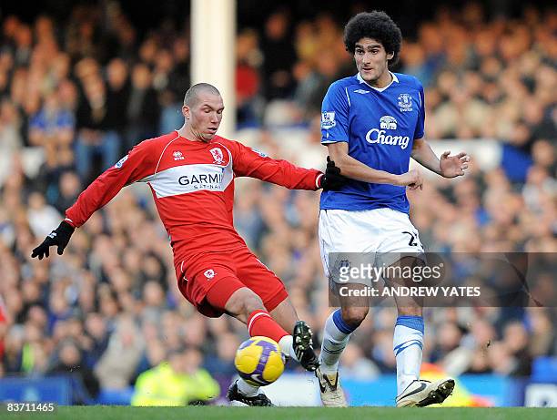 Middlesbrough's French midfielder Didier Digard vies with Everton's Marouane Fellaini during the English Premier League football match at Goodison...