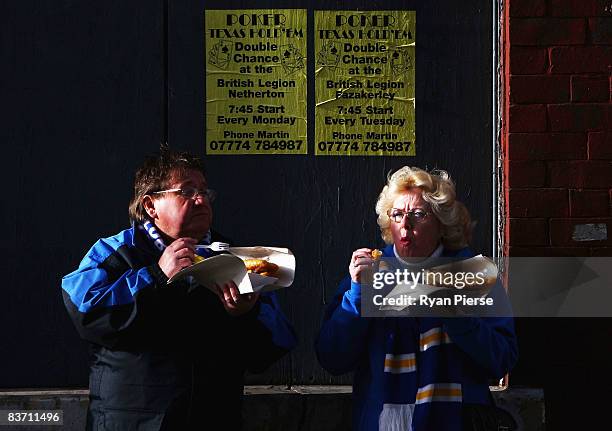 Everton fans eat fish and chips outside the ground before the Barclays Premier League match between Everton and Middlesbrough at Goodison Park on...