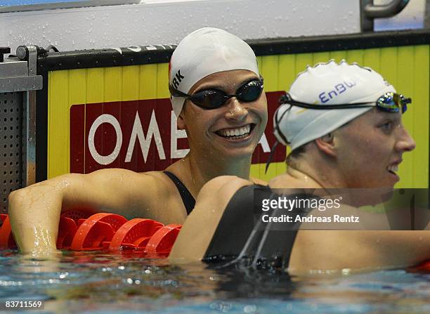 Tara Kirk of the USA celebrates as Janne Schaefer of Germany reacts after the final of the women's 50m breaststroke event at the FINA short course...