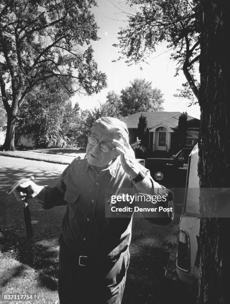 Denver Forester Ray Howe stands next to a tree that has been killed by Dutch Elm Disease. He used the hammer to pull away the bark to show us some...