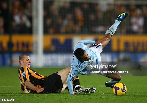 Dean Marney of Hull City tackles Robinho of Manchester City during the Barclays Premier League match between Hull City and Manchester City at The KC...