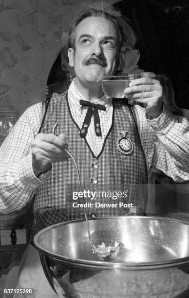 William E. Sweet Jr., pinch hitting as bartender, samples the punch before serving it to the thirsty throng. The party, which honored the Carl...