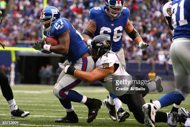 Brandon Jacobs of the New York Giants runs the ball as Justin Bannan of the Baltimore Ravens defends during their game on November 16, 2008 at Giants...