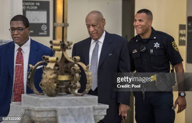 Andrew Wyatt, left, leads Bill Cosby, center, toward Courtroom A at the Montgomery County Courthouse August 22, 2017 in Norristown, Pennsylvania....