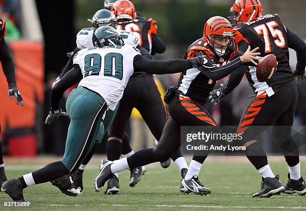 Ryan Fitzpatrick of the Cincinnati Bengals is tackled by Darren Howard of the Philadelphia Eagles during the NFL game at Paul Brown Stadium on...