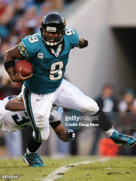 Quarterback David Garrard of the Jacksonville Jaguars avoids a sack by safety Michael Griffin of the Tennessee Titans at Jacksonville Municipal...