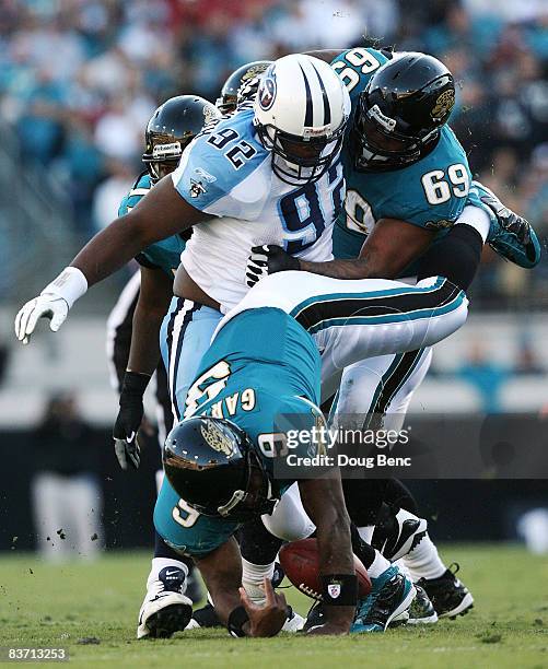 Quarterback David Garrard of the Jacksonville Jaguars fumbles as he is sacked by defensive tackle Albert Haynesworth of the Tennessee Titans while he...