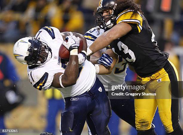 LaDanian Tomlinson of the San Diego Chargers scores a first quarter touchdown while taking a hit from Troy Polamalu of the Pittsburgh Steelers during...