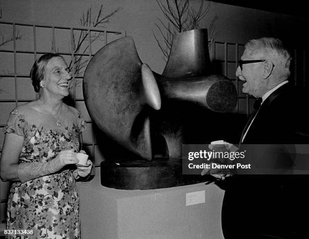 Henry Moore Exhibition Display On Through July 2 Examining a sculpture by Henry Moore at Schleier Gallery in Denver Art Museum are Mr. And Mrs. Wayne...