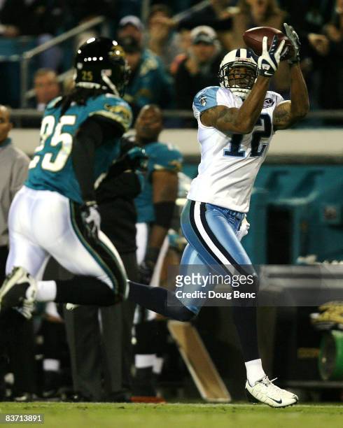 Wide receiver Justin Gage of the Tennessee Titans catches a touchdown pass in the third quarter past safety Reggie Nelson of the Jacksonville Jaguars...
