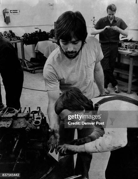 Ron Casados, auto mechanics assistant, Denver Community College, Red Rocks, offers help to Debbie Squires in engine disassembly. Credit: Denver Post,...