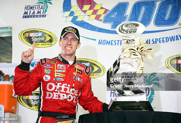 Carl Edwards, driver of the Office Depot Ford, celebrates in victory lane after winning the NASCAR Sprint Cup Series Ford 400 at Homestead-Miami...