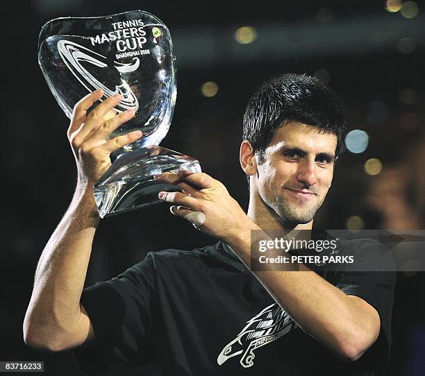 Novak Djokovic of Serbia holds up the winner's trophy following his victory over Nikolay Davydenko of Russia in the men's singles final at the ATP...