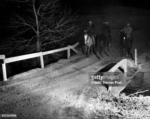 Three members of the Jefferson County Sheriff's Mounted Posse trade queries during their search for Adolph Coors, III millionaire head of the Coors...