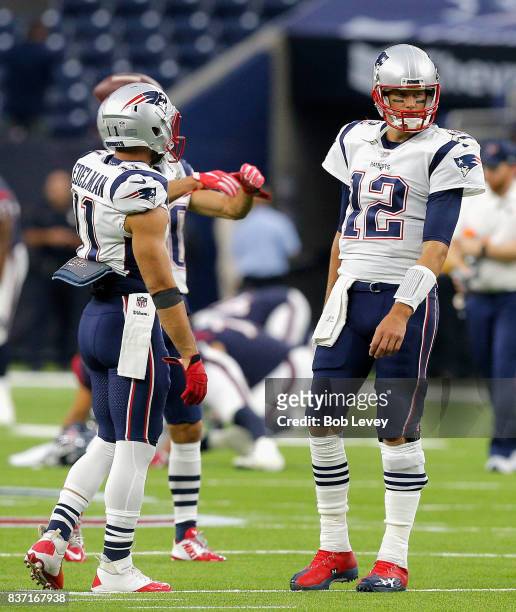 Tom Brady of the New England Patriots and Julian Edelman warms up before playing the Houston Texans in a preseason game at NRG Stadium on August 19,...