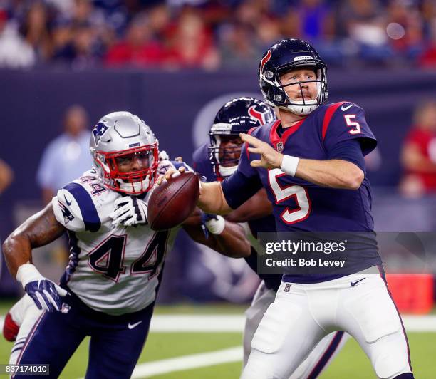 Brandon Weeden of the Houston Texans is pressured by Trevor Bates of the New England Patriots in a preseason game at NRG Stadium on August 19, 2017...