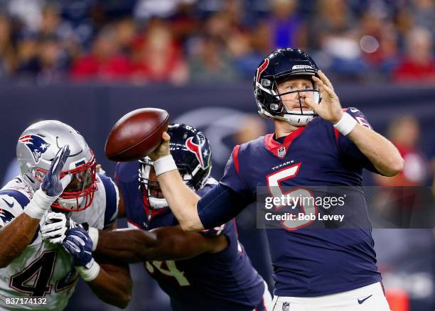 Brandon Weeden of the Houston Texans is pressured by Trevor Bates of the New England Patriots in a preseason game at NRG Stadium on August 19, 2017...