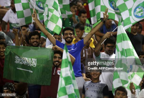 Supporters of Saudi Arabia's Ahli Ahly FC cheer during the AFC Champions League qualifying football match between Iran's Persepolis FC and Saudi...