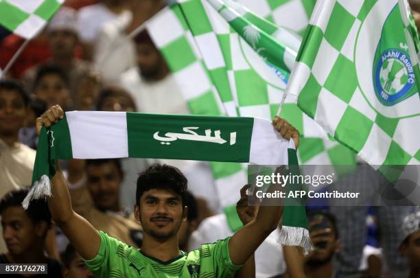 Supporters of Saudi Arabia's Ahli Ahly FC cheer during the AFC Champions League qualifying football match between Iran's Persepolis FC and Saudi...