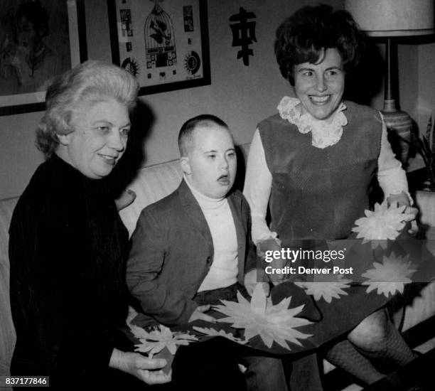 Adams-Arapahoe Women Help School Mrs. Perry Clark, left, 13904 E. 2nd Ave., and Mrs. Ted Christian, 200 Salem St., show a daisy-decorated banner to...