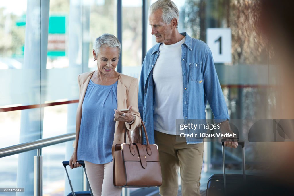 Senior couple walking together on public transport station