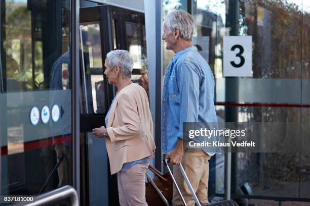senior couple, waiting for a bus, at public transport station - airport bus stock pictures, royalty-free photos & images