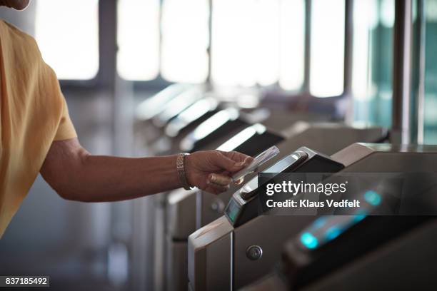 senior woman checking in at metro station - identity card stock pictures, royalty-free photos & images