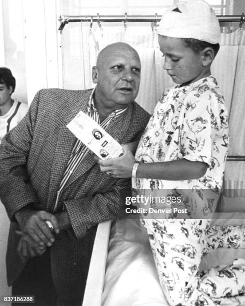 Star Visits Denver Jackie Coogan, who plays Uncle Fester on TV's "The Addams Family," gives an Uncle Fester doll to one of his fans, Don Sickels son...