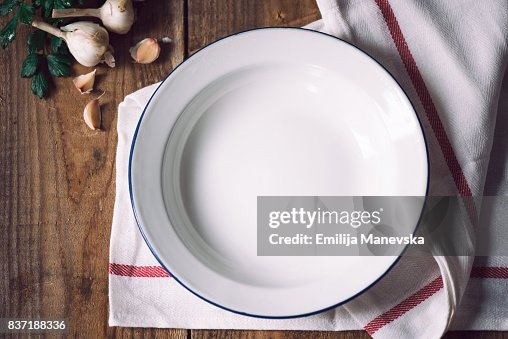 Empty white metal plate with napkin Empty white metal plate with napkin