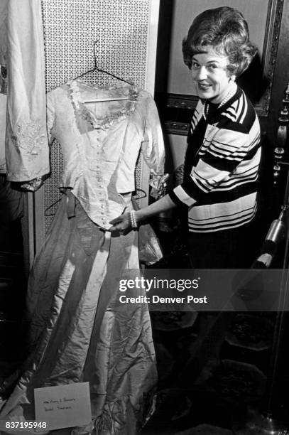 Victorian Wedding Gown Displayed Mrs. Tom Currigan looks at the Victorian wedding gown of Mrs. Henry C. Brown at the Sewall Auxiliary benefit....