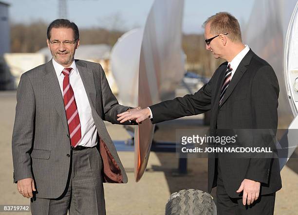 Brandenburg State Premier Matthias Platzeck and CEO of Vestas Deutschland GmbH Hans-Joern Rieks pose next to giant blades used for wind farms as...