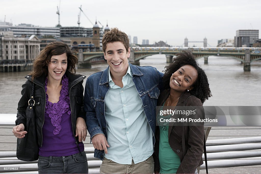Friends posing by River Thames