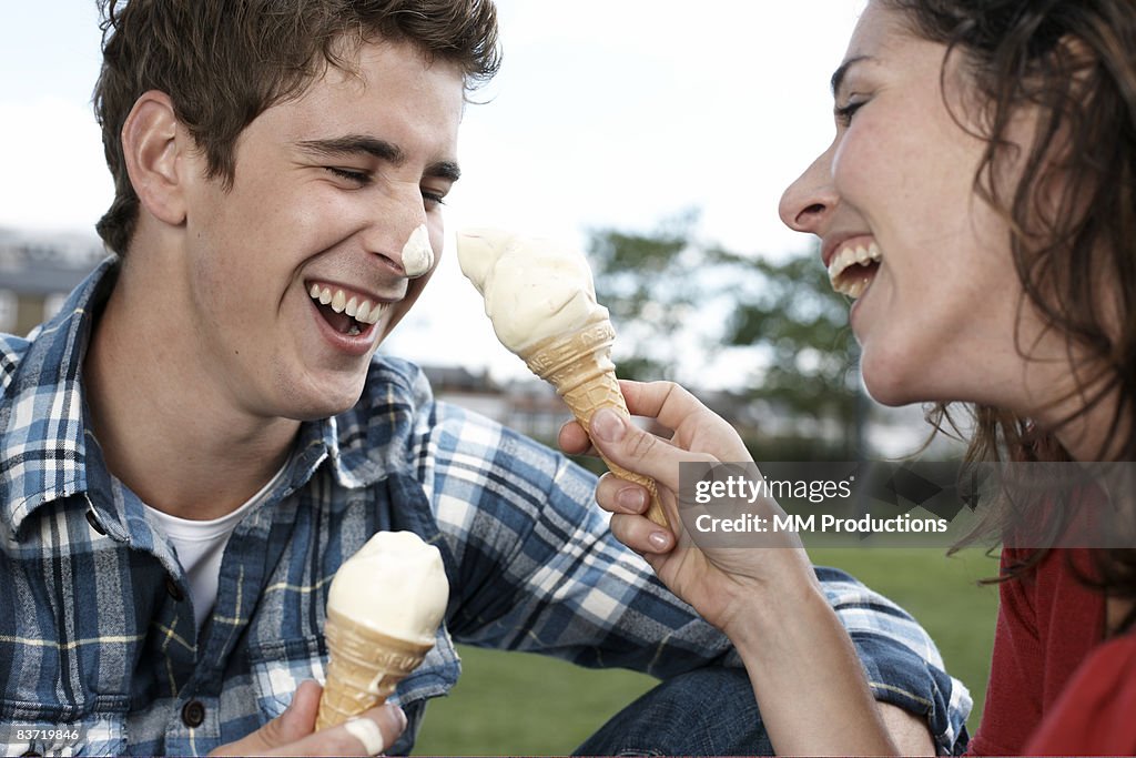 Couple playing with ice cream cones